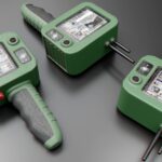 Three green medical devices on a gray surface