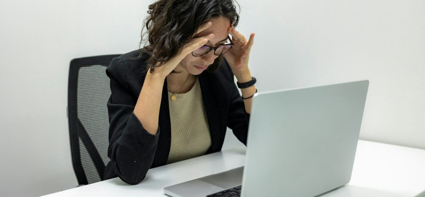 a woman sitting in front of a laptop computer