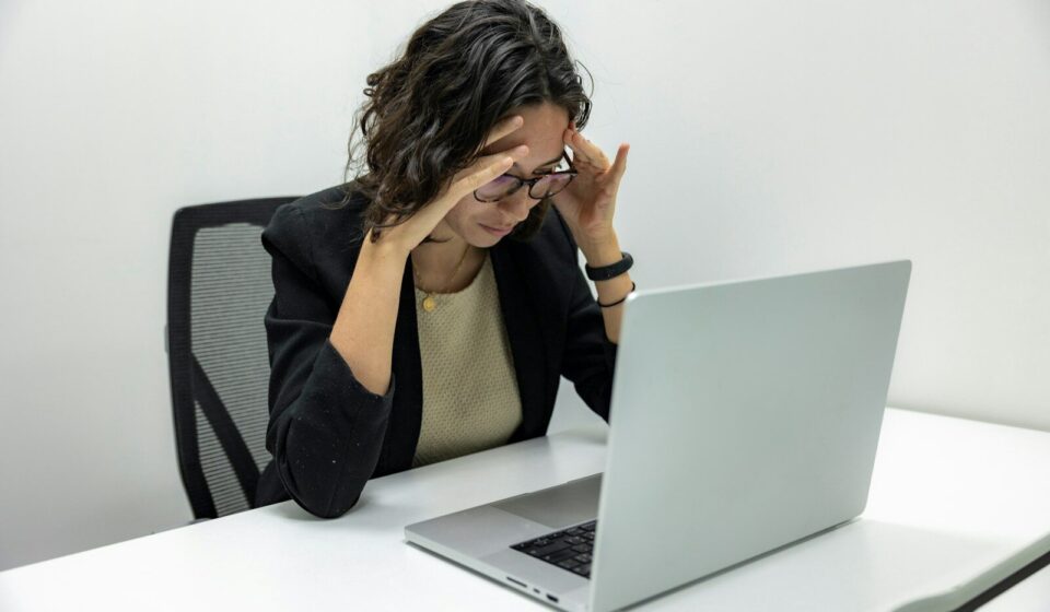 a woman sitting in front of a laptop computer