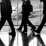 man in black pants and black jacket walking on ice covered ground